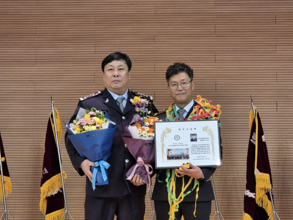 보성군자율방범연합대 이취임식에서 이임하는 제13대 정해만 대장(사진 오른쪽)이 취임하는 제14대 황은철 대장(사진 왼쪽)으로 부터 재직기념패를 전달 받고 기념사진을 찍고 있는 모습
